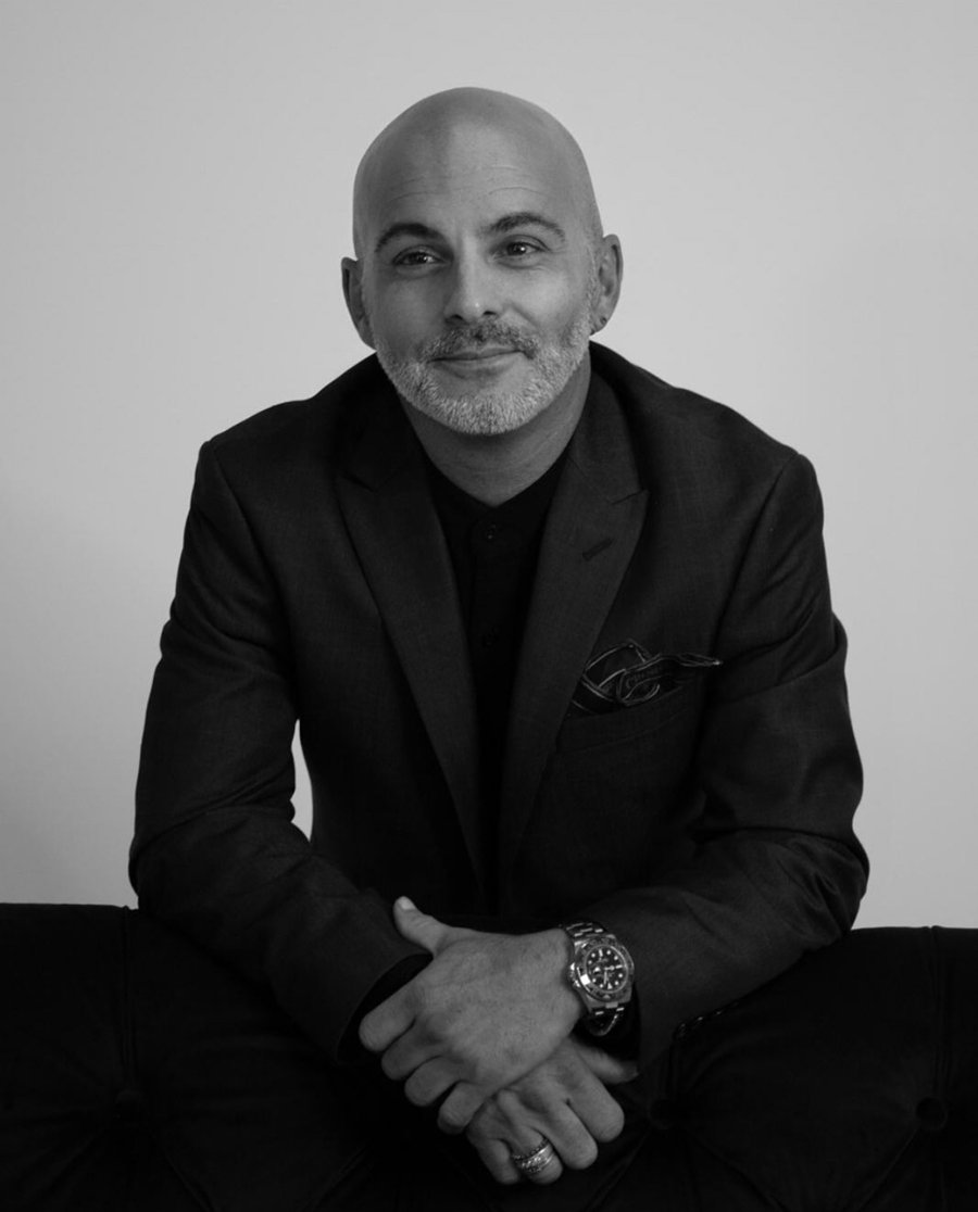 Arturo Rovirosa, black and white portrait in a dark jacket, hands folded