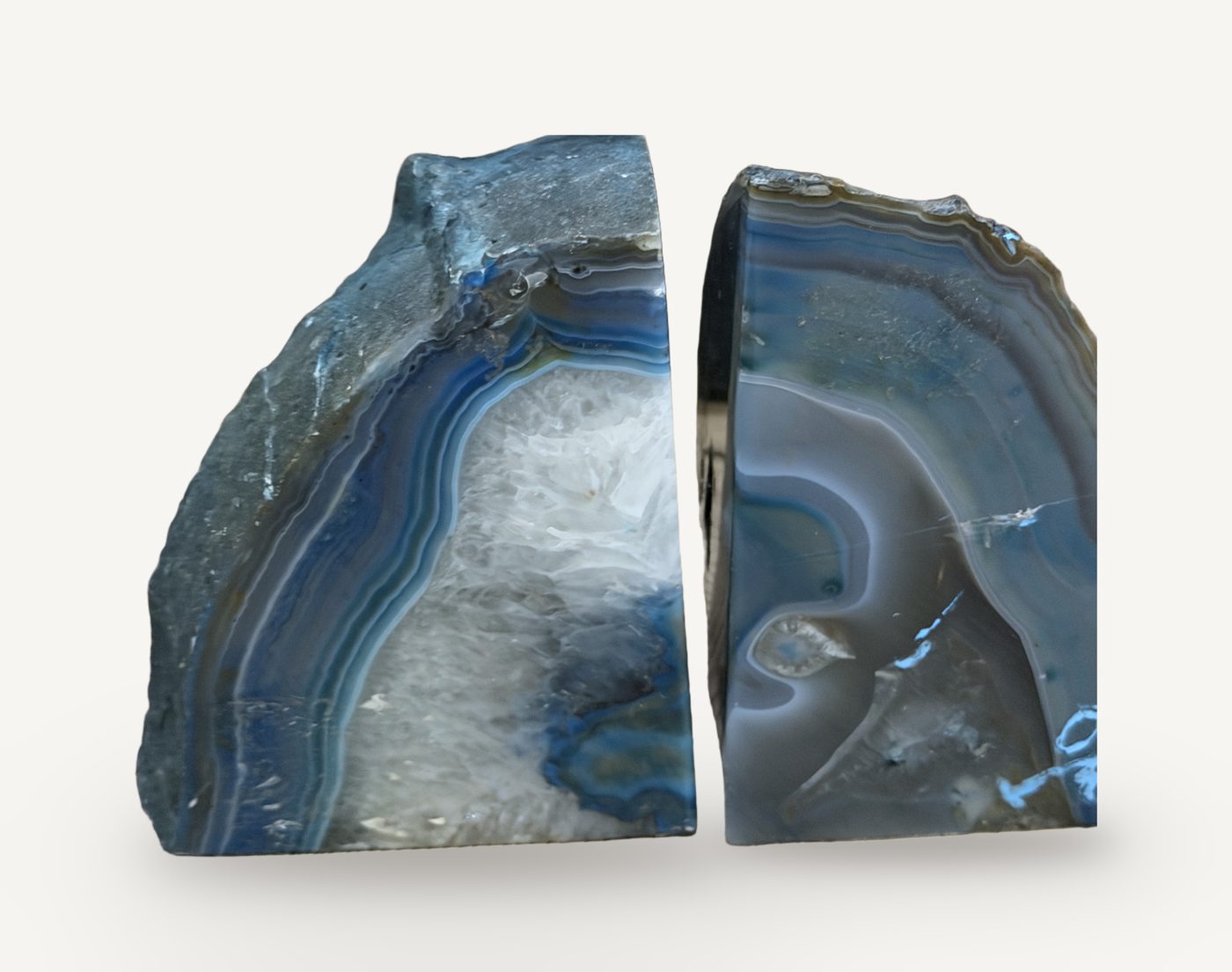 A pair of blue banded agate geode halves standing as bookends