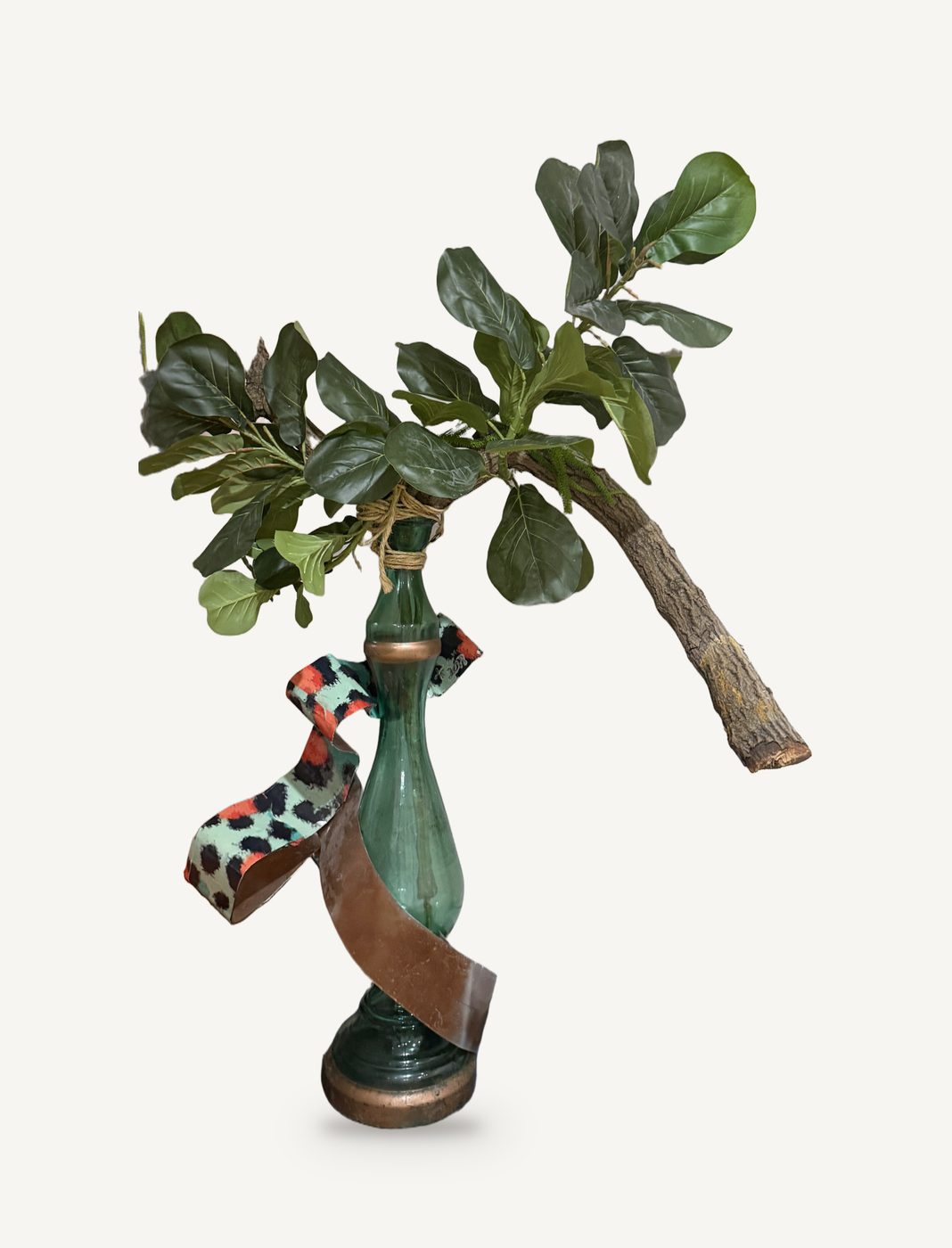 Eden, Secondhand: a green glass vase wrapped in copper ribbon and a leopard-print band, with a leafy branch rising from its neck