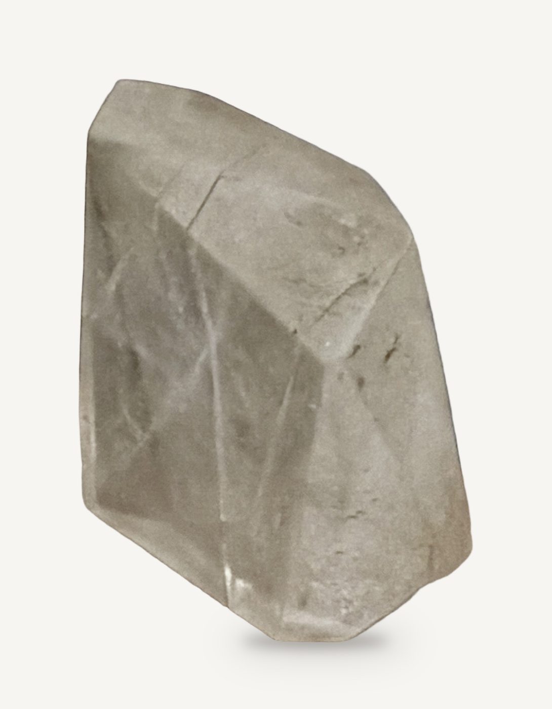 A clear faceted acrylic block standing upright, resembling a raw quartz crystal