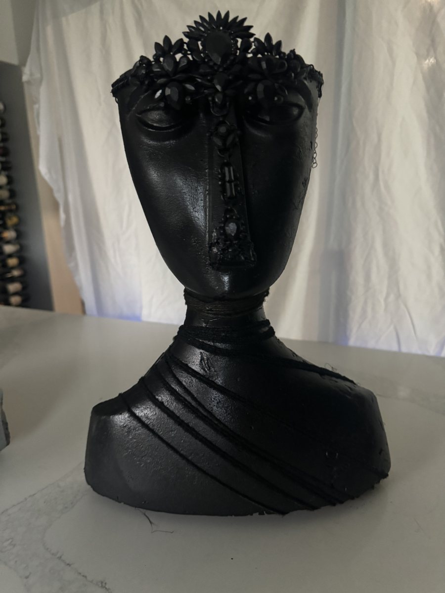 The Night Queen: a matte black cast head with a jeweled crown