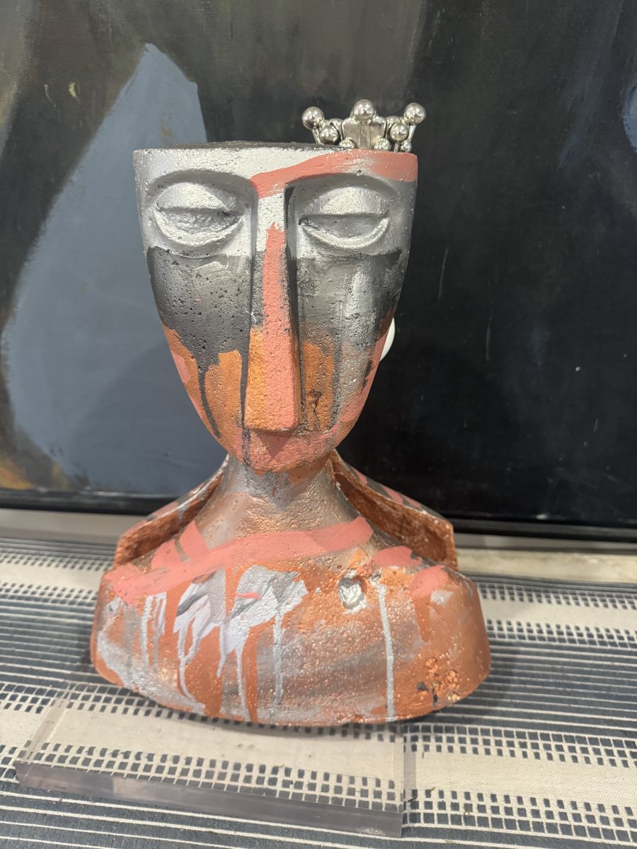 Two Minds: a terracotta head with two stacked silver faces